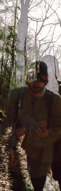 Jakob Schlenker walking through a sunlit forest